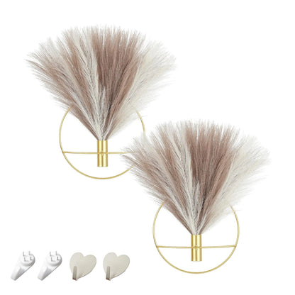 Boho wall decor featuring two wall-mounted metal decorations with faux pampas grass and gold rings.